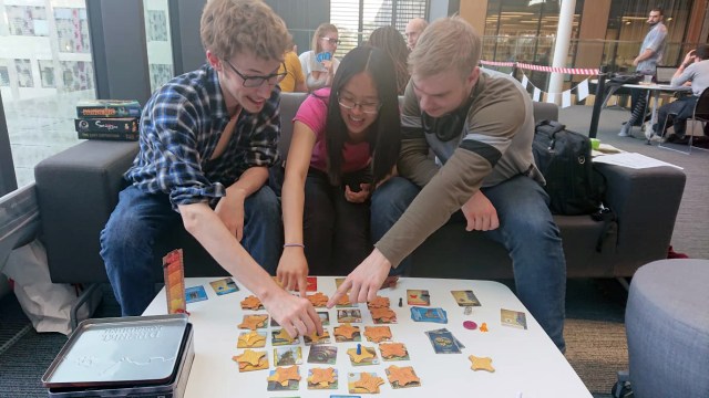 Students playing Forbidden Desert board game