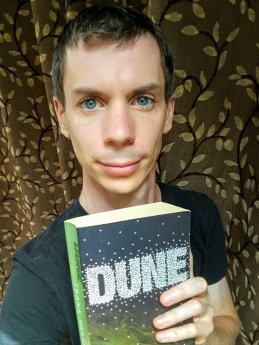 Dan Croft holding a copy of Dune